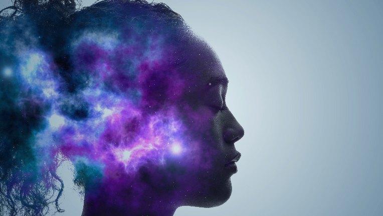 Side profile of woman’s face with purple and blue nebula imposed on it