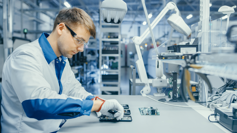 Man in high-tech factory building a microchip